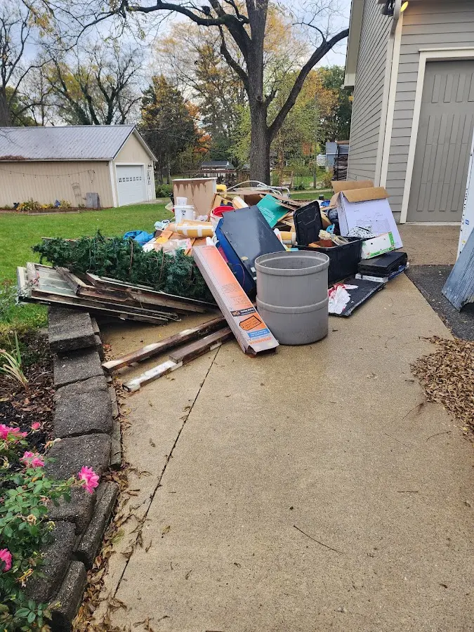 Dumpster being loaded with debris for 10 Yard Dumpster Rental in Pueblo West
